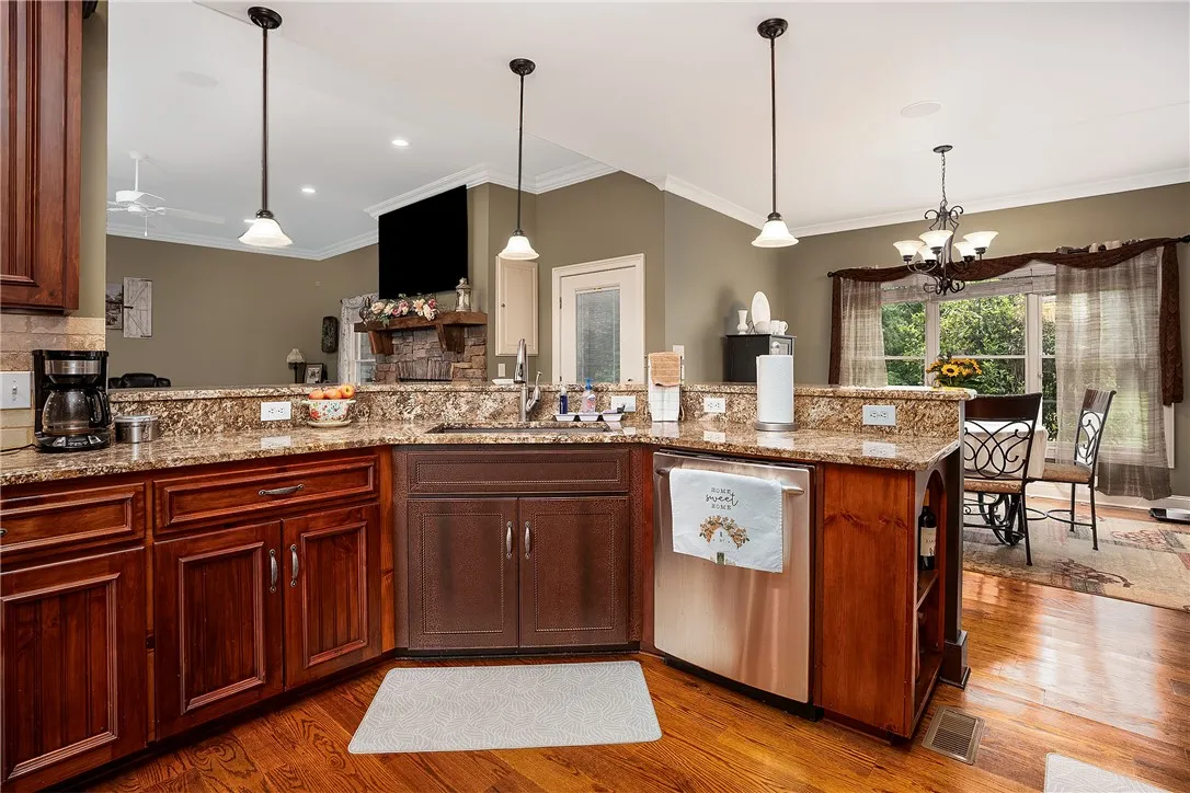 Granite counters and rich wood cabinetry define this well-appointed kitchen, seamlessly connecting to the dining area.