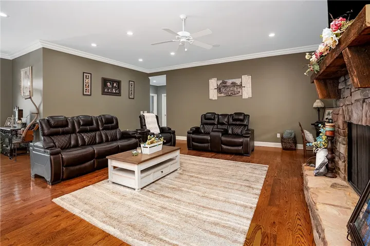 A well-lit gathering space features crown molding, recessed lighting, and rich hardwood floors.