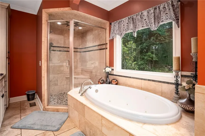 Luxurious jetted tub and a spacious walk-in shower provide a private spa experience.