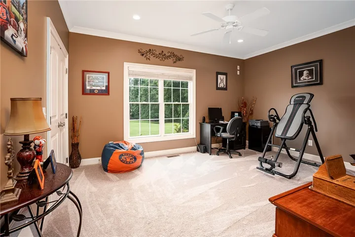 Well-lit room with ample natural light, ideal for a productive home office or exercise space.