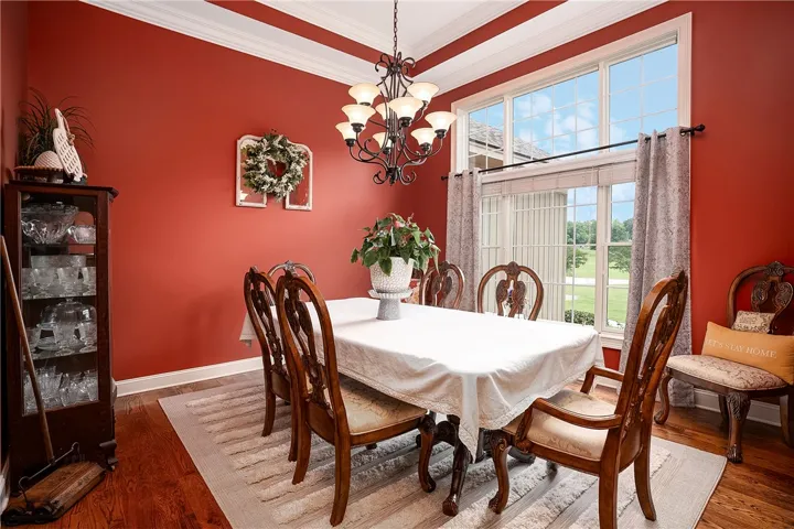 A refined dining room with crown molding and hardwood flooring, perfect for entertaining.