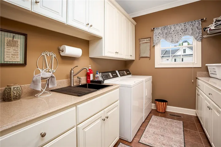 Ample storage and a dedicated sink make laundry day effortless.