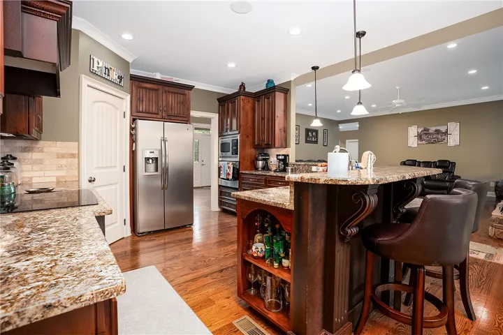 A well-appointed kitchen showcasing an inviting island with built-in storage and rich wood flooring.