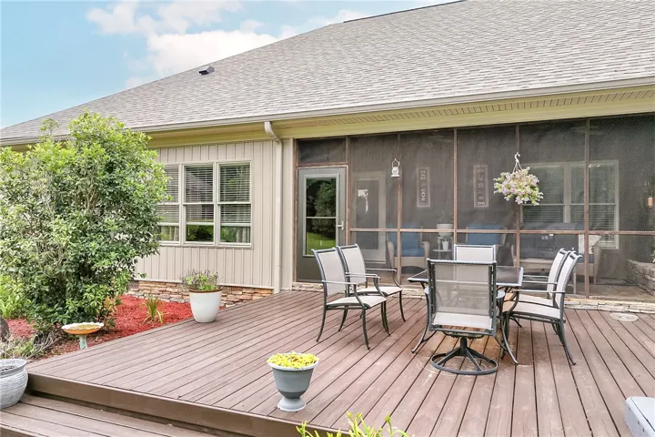 A spacious wooden deck provides ample room for outdoor enjoyment and entertaining.