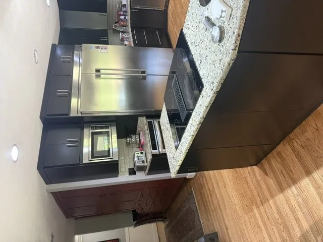 Culinary excellence awaits in this well-appointed kitchen featuring a substantial island and gleaming stainless steel appliances.