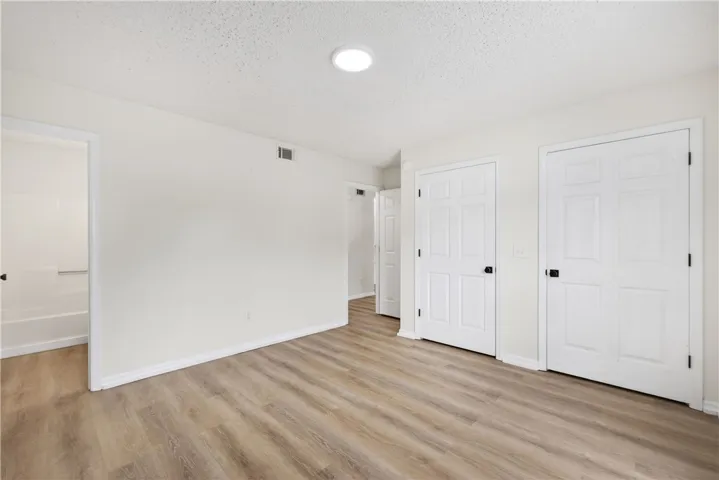 Newly installed wood flooring creates a pristine backdrop for any bedroom design.