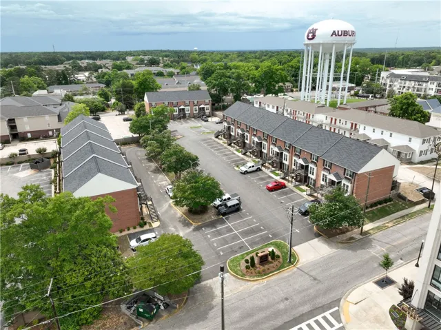 An aerial perspective reveals a vibrant neighborhood with multi-unit dwellings and a clear view of the iconic water tower.