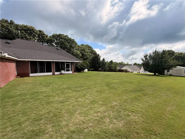 An expansive backyard lawn offers ample space for outdoor enjoyment and potential landscaping enhancements.