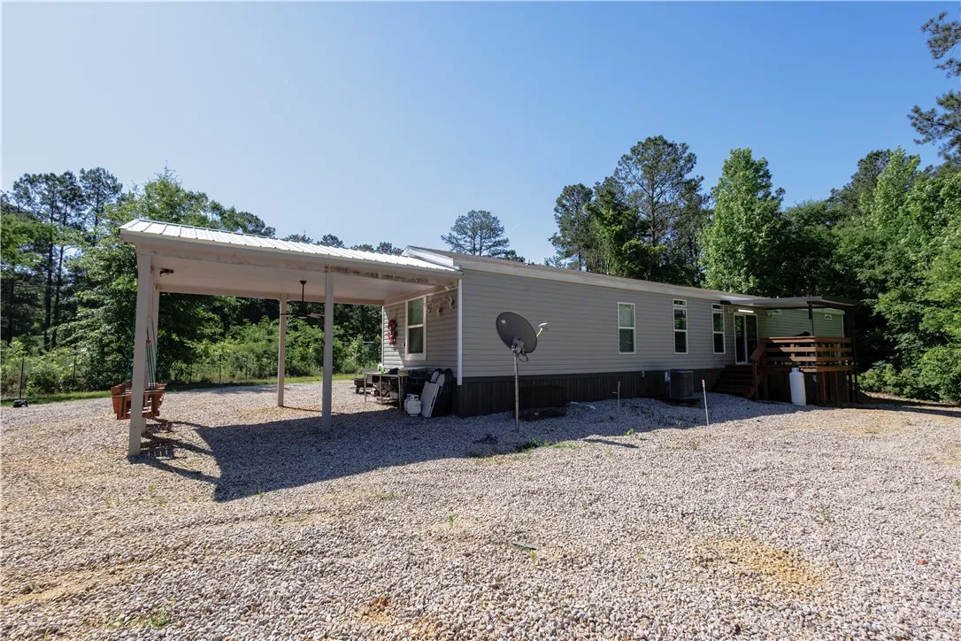 A tranquil, tree-lined lot provides a serene setting for this inviting home with a welcoming covered patio.