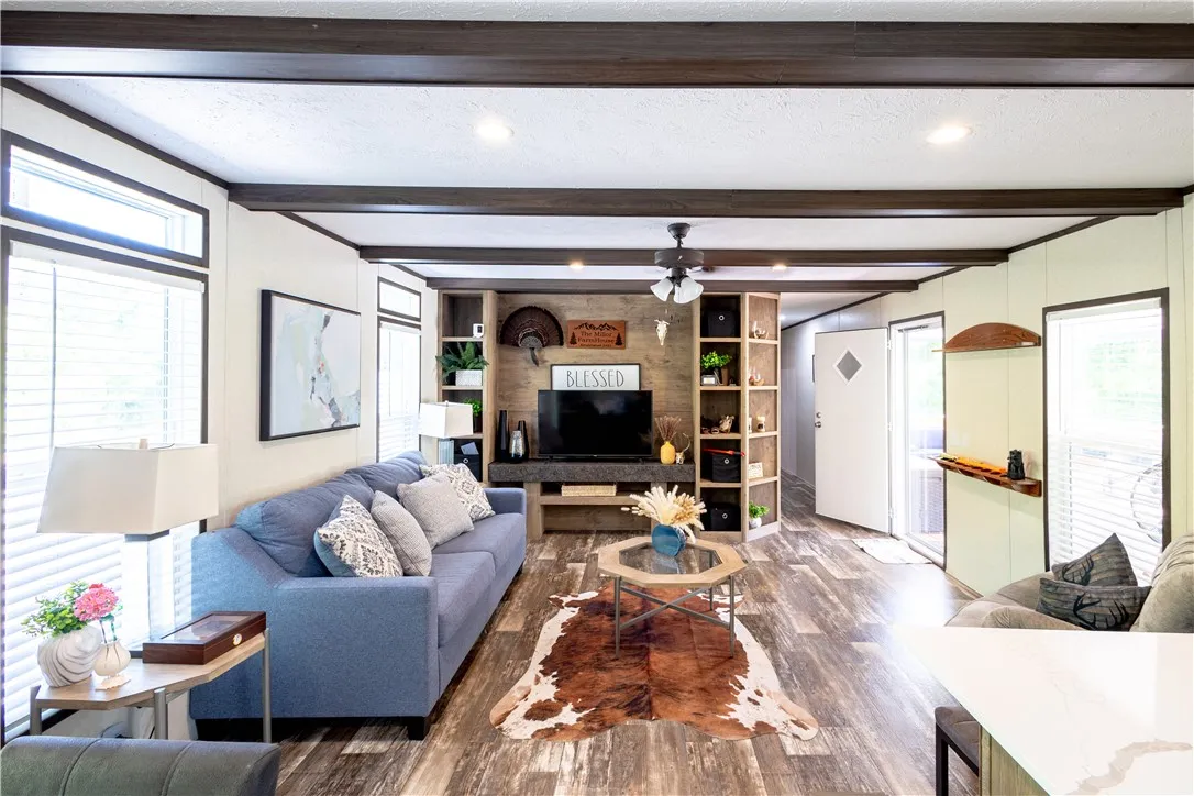 Rich wood-toned ceiling beams complement the flooring, creating an inviting, cohesive living area.