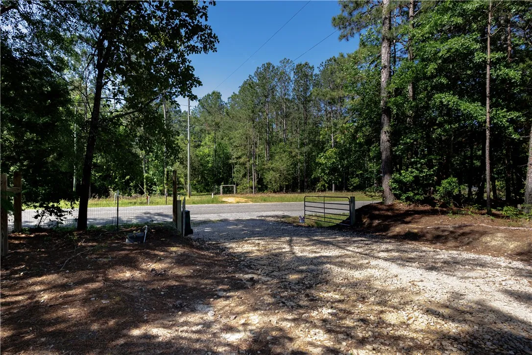 A private gravel driveway leads to this secluded, wooded property, offering a tranquil escape.