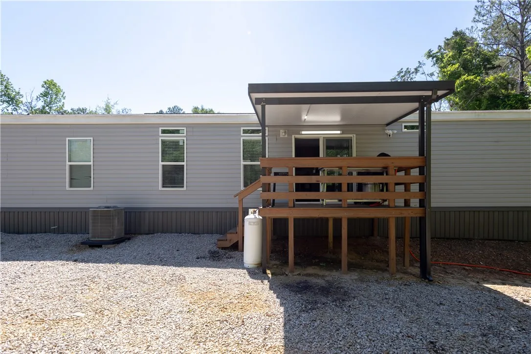 A generous covered deck extends from this modern home, offering an ideal space for outdoor enjoyment.