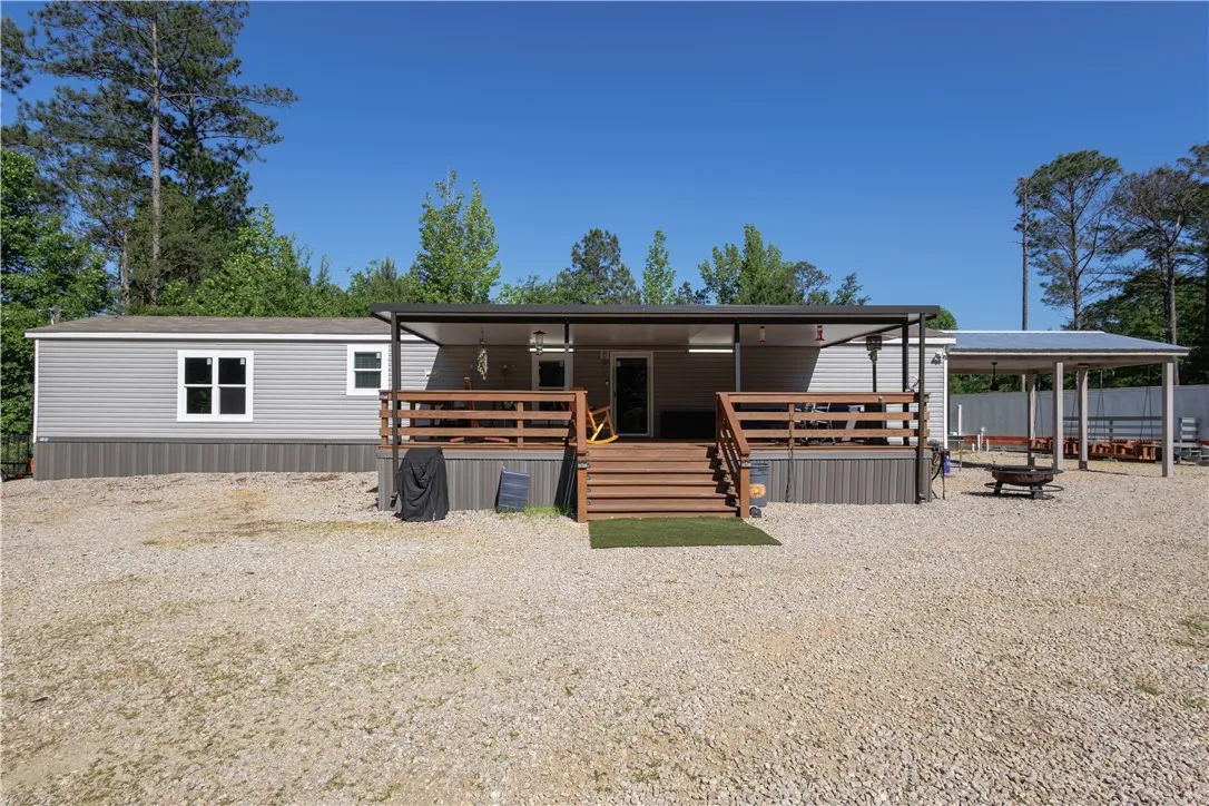 A welcoming front deck and inviting outdoor living space beckon at this charming home.