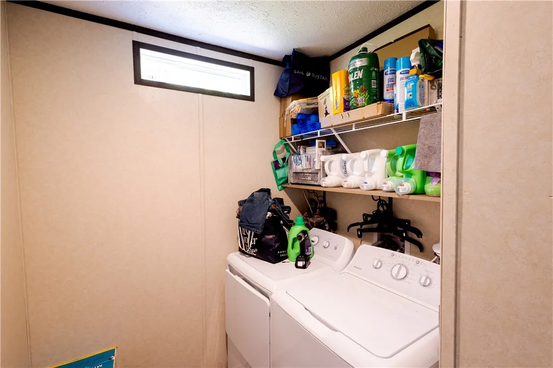A dedicated utility space with practical shelving and modern appliances for efficient home management.