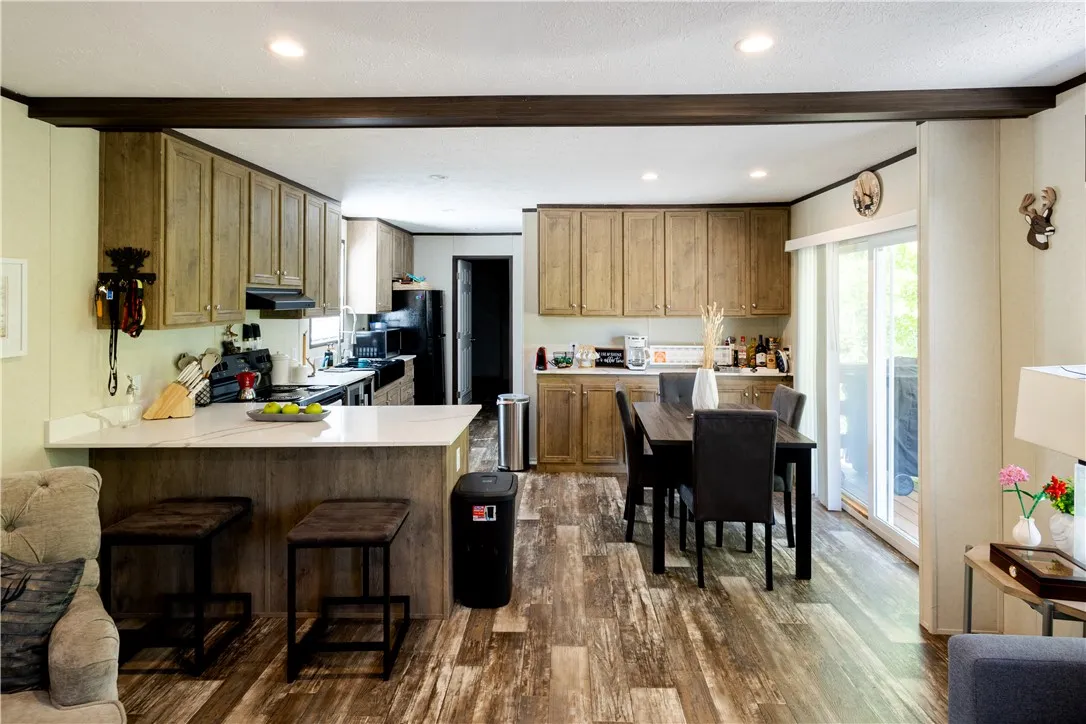 An open-concept living space highlights a well-appointed kitchen and dining area.