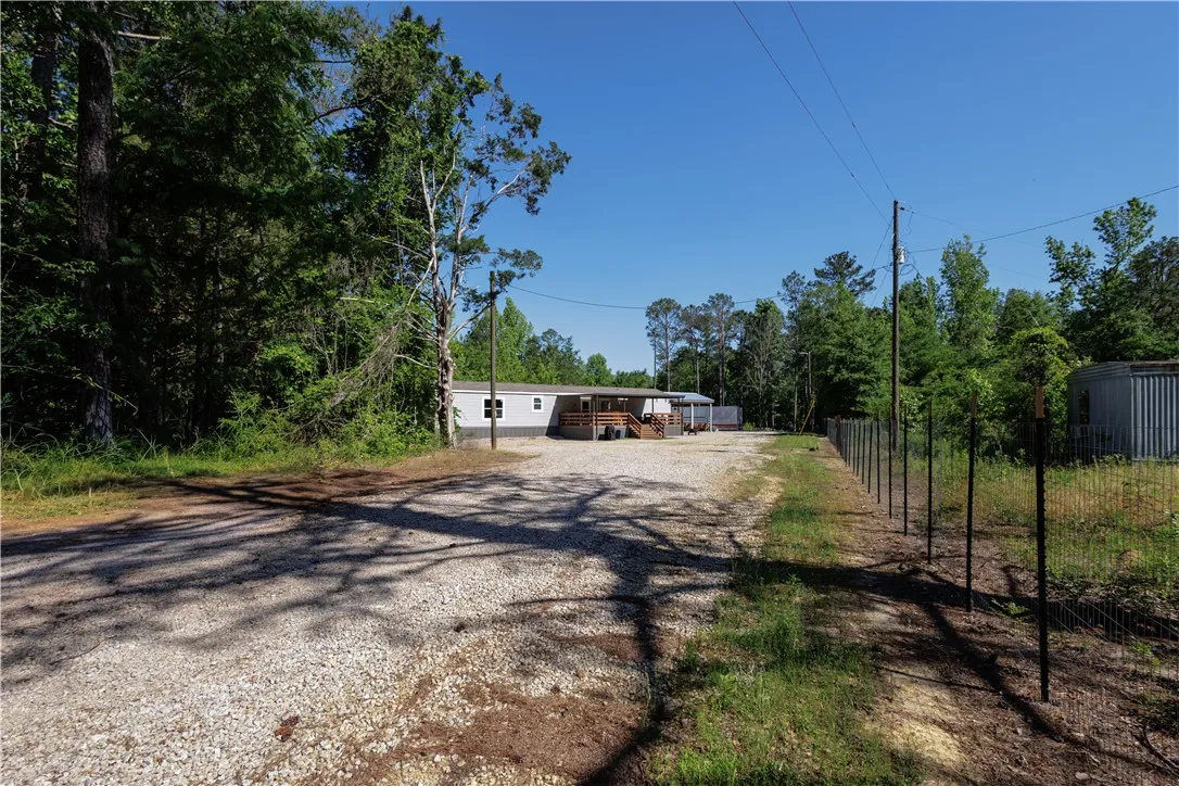 A private, secluded home with ample parking, surrounded by mature trees.