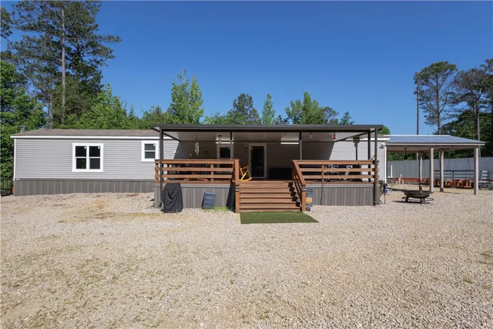 A welcoming front deck and inviting outdoor living space beckon at this charming home.