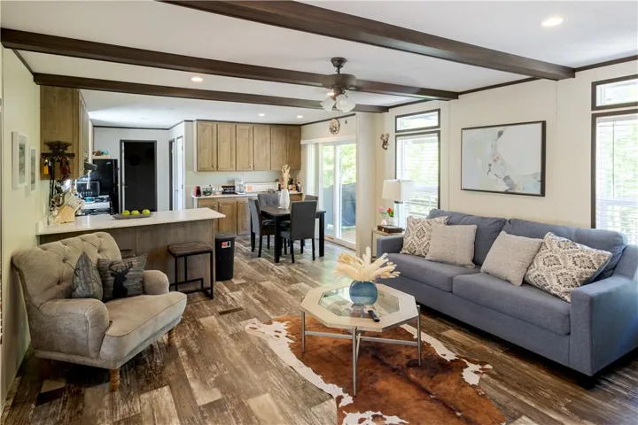 An open concept living area features an eat-in kitchen, a spacious family room, and rich wood-toned flooring.