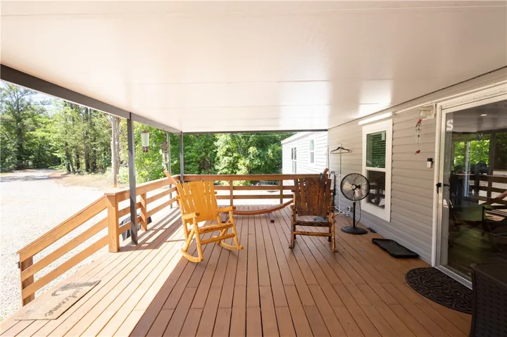 A spacious covered deck provides an inviting outdoor living area for relaxation.