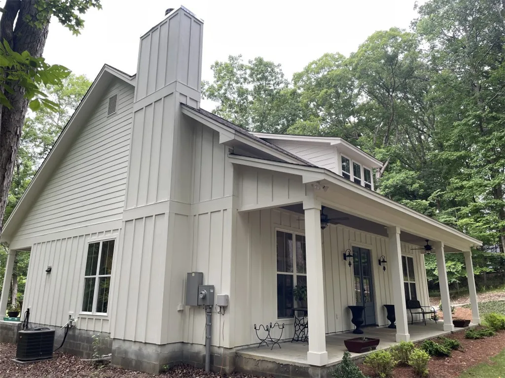 A welcoming front porch extends across this charming residence, perfect for outdoor relaxation.