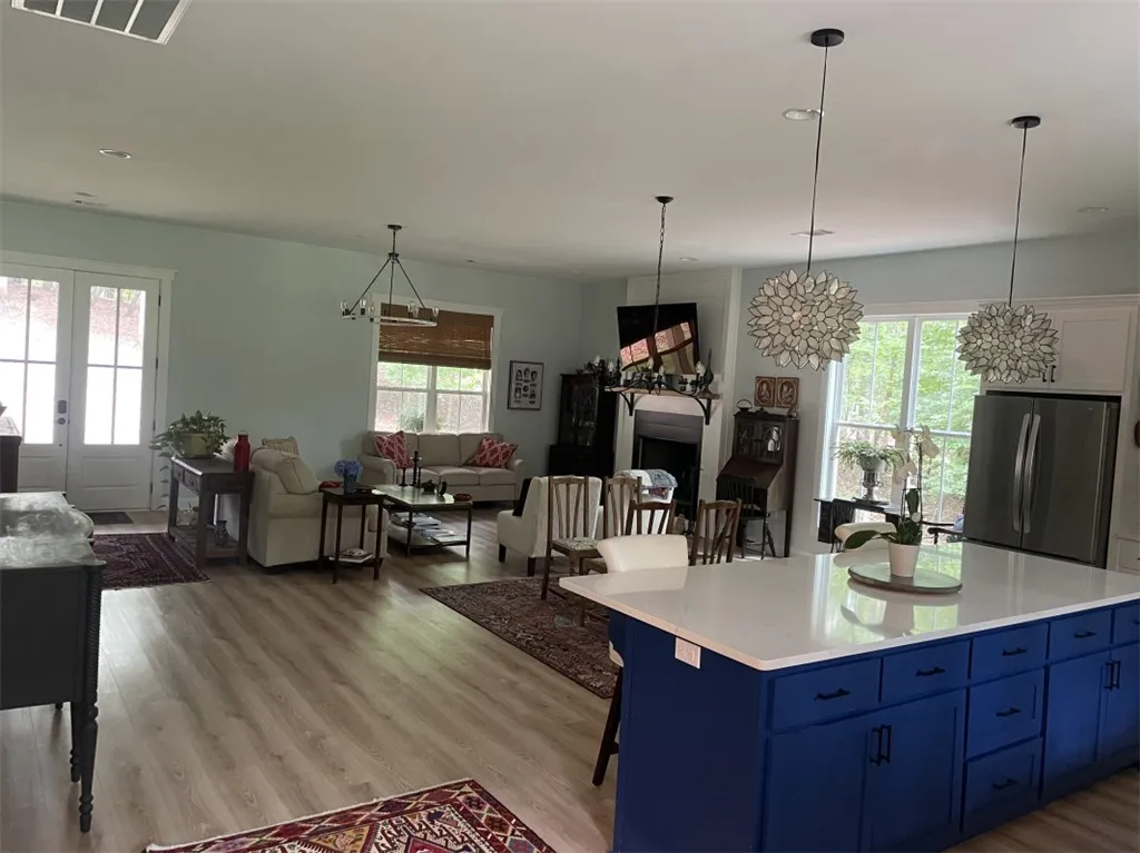An open concept living area blends a cozy family room with an inviting kitchen, perfect for entertaining.