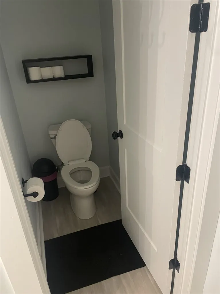 A well-appointed, compact half-bath provides essential convenience with stylish flooring.
