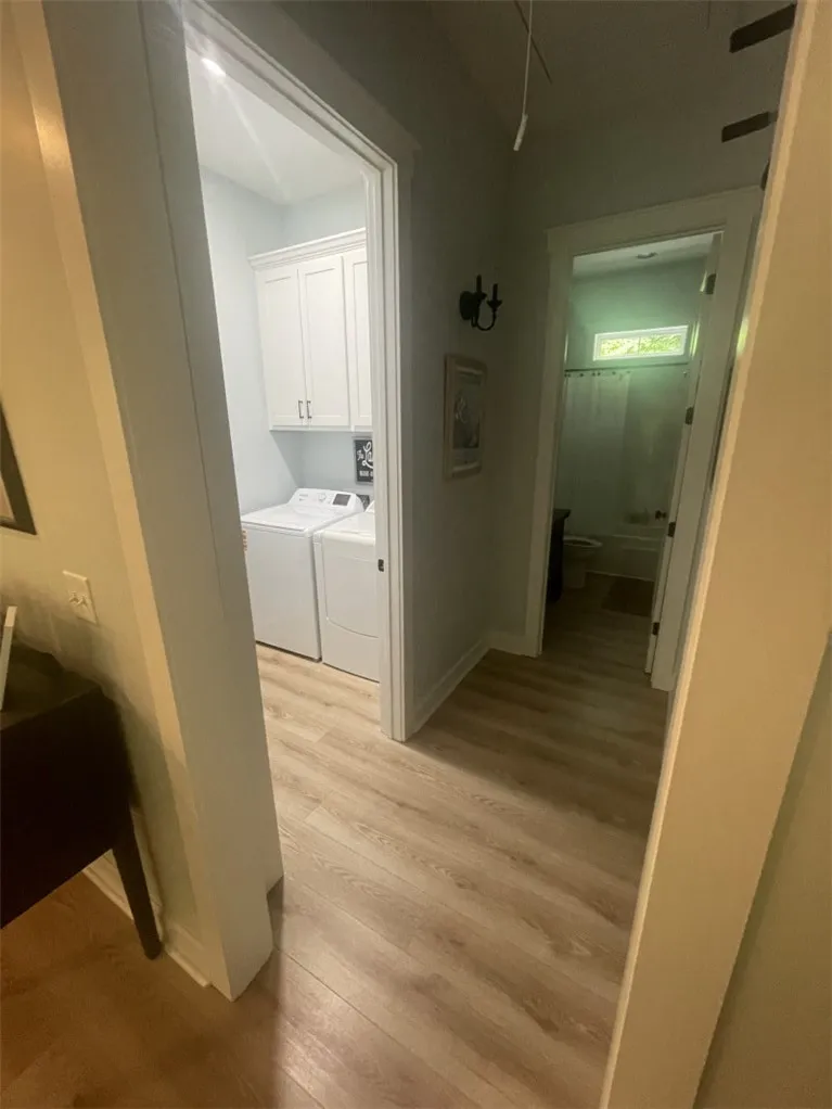Functional laundry room and hall bath feature practical design and clean lines.