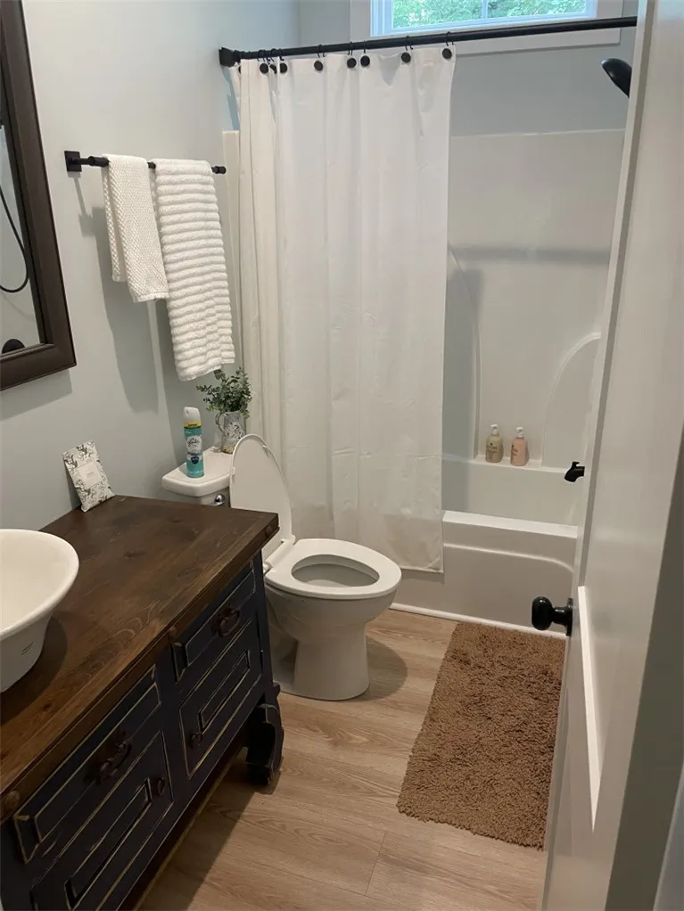 A classic bath with a modern vanity, offering comfort and convenience.