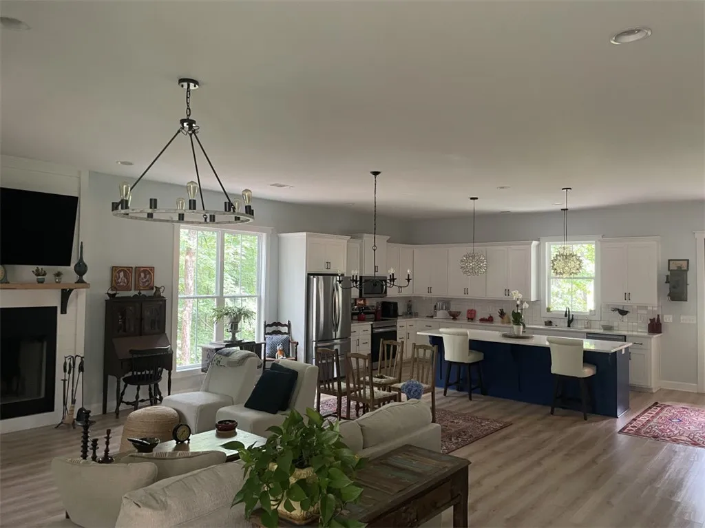 An open-concept living space integrates a well-appointed kitchen and comfortable lounge area, all illuminated by abundant natural light.