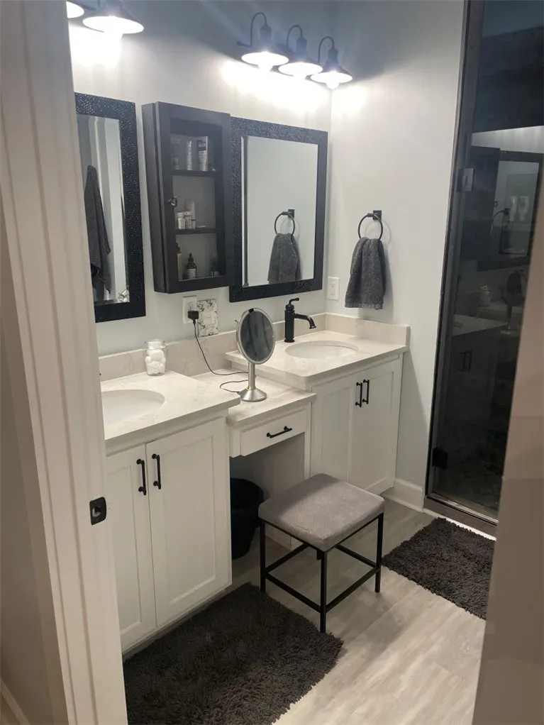 Dual vanities and ample counter space enhance this well-appointed bathroom.