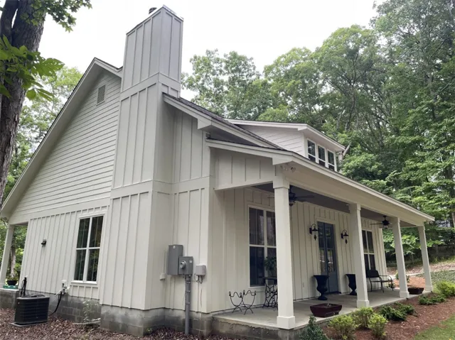 A welcoming front porch extends across this charming residence, perfect for outdoor relaxation.