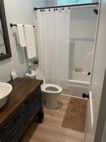 A classic bath with a modern vanity, offering comfort and convenience.