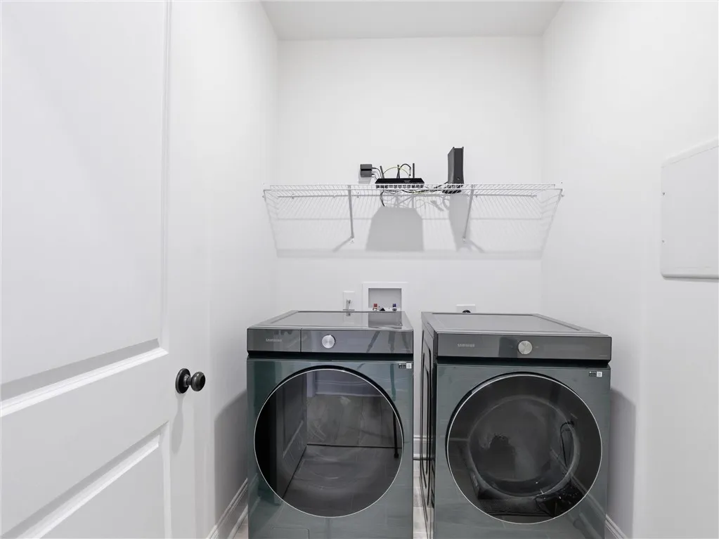 Discover convenience with a dedicated laundry room featuring modern appliances.