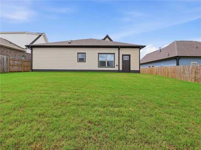 A spacious backyard with vibrant green grass, perfect for outdoor activities.