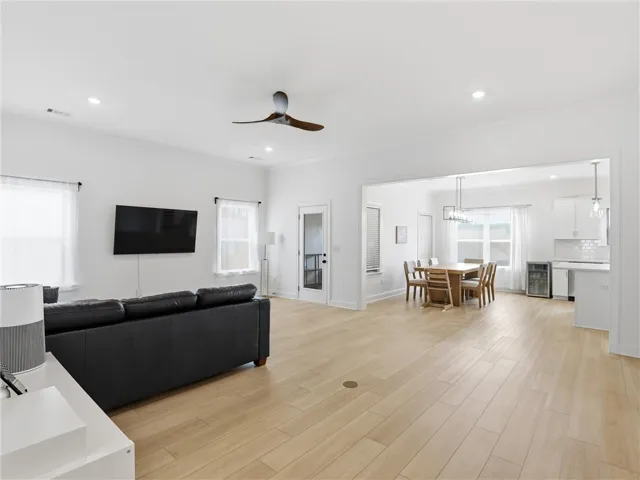 An open concept floorplan seamlessly connects the living room, dining area, and kitchen, creating an inviting space.