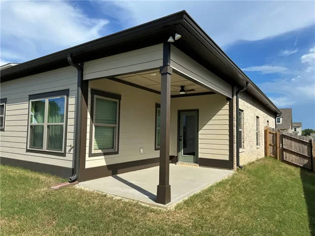 An inviting covered patio offers a comfortable outdoor living space for relaxation and entertainment.