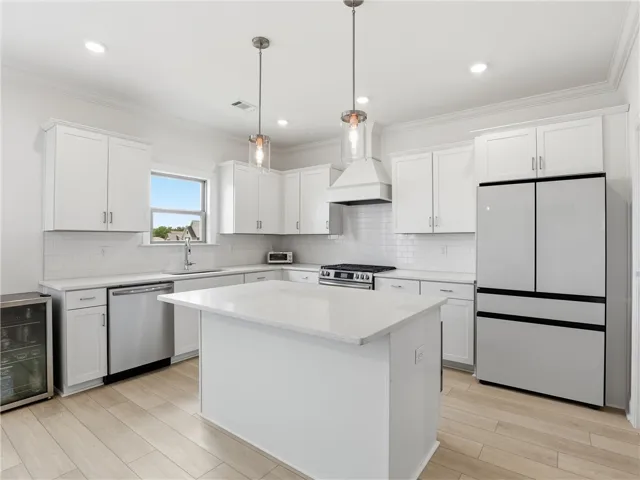 Culinary delights await in this bright, open kitchen featuring a large island and ample counter space.