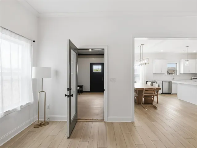 Blonde hardwood floors flow seamlessly throughout this open-concept home, connecting the inviting living spaces.