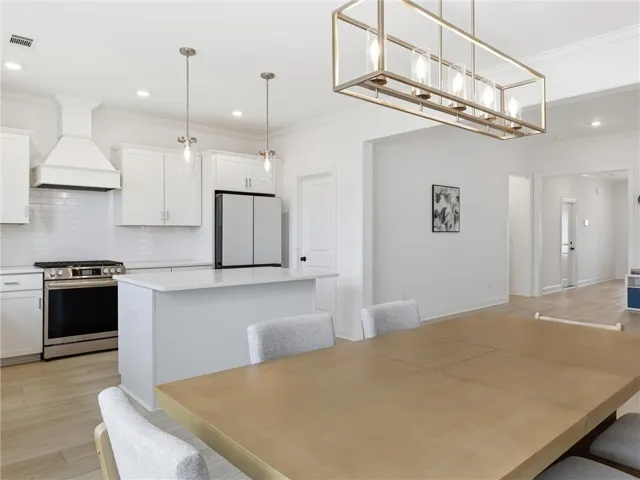 An open concept design seamlessly integrates this well-appointed kitchen with the adjacent dining space.