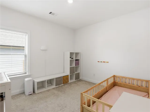 A well-lit room with soft carpeting offers a calm and inviting atmosphere.