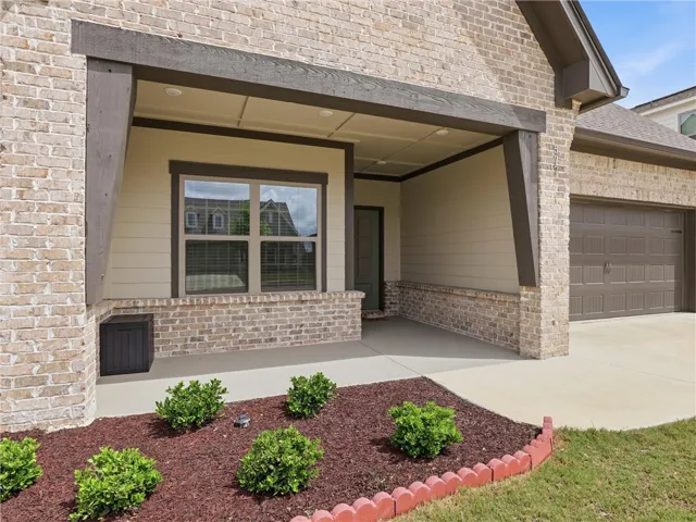A welcoming covered entry provides shelter and charm at this brick-front home.