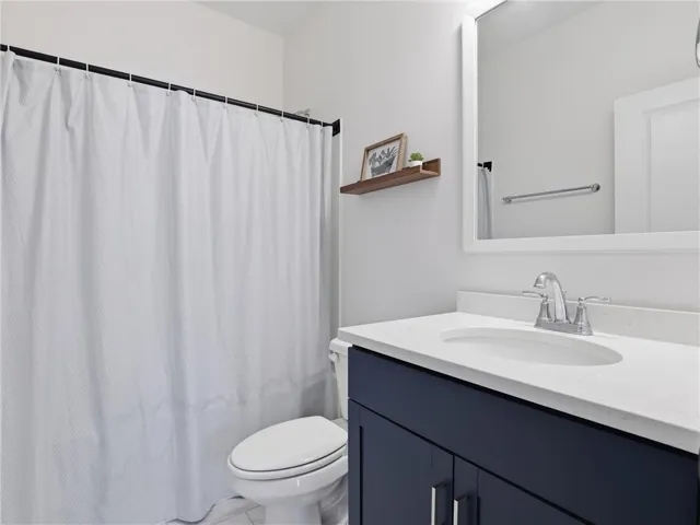 A well-appointed lavatory offers a spacious vanity, toilet, and convenient shower area.