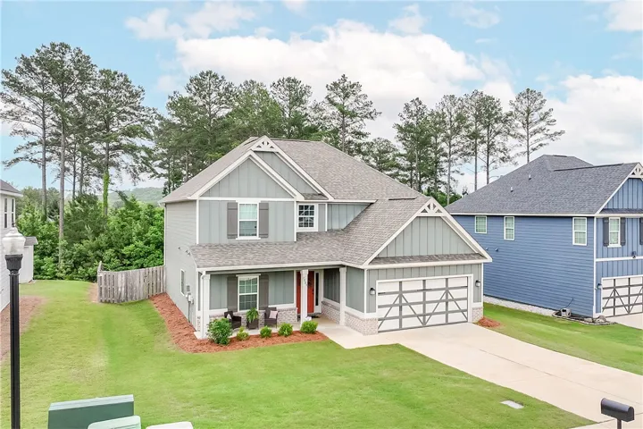 An inviting front porch welcomes you to this residence with an attached garage and generous yard.