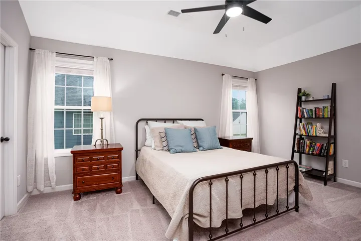 A well-lit bedroom provides a cozy retreat.