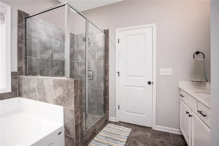 Luxurious bathroom retreat featuring a spacious shower and a soaking tub.
