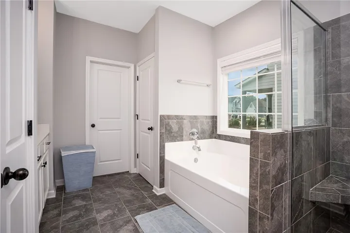 A well-appointed bathroom offering a soaking tub and a separate glass-enclosed shower.
