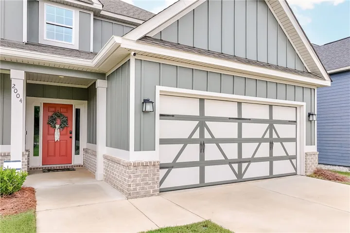 A welcoming front entrance featuring a stylish garage and a vibrant entry door.
