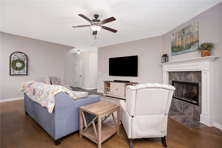 A refined living space features hardwood floors and a cozy fireplace.