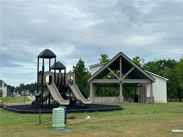 A community playground and covered picnic area invite outdoor enjoyment.