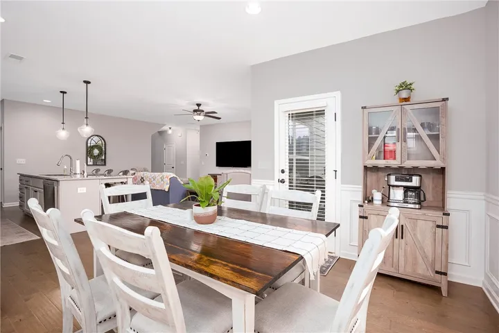 Hardwood floors flow through this dining area, featuring a  glass exit door.